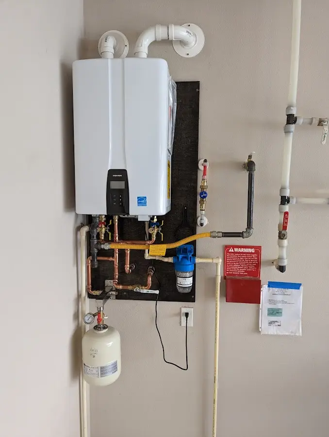 Professional plumber installing copper piping in a Tiger Point home